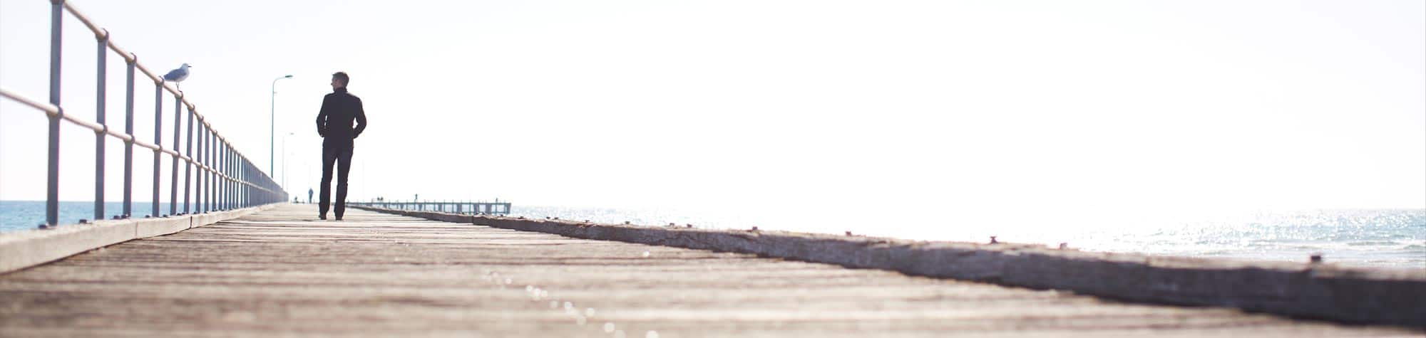 Mark Dobson walking along pier